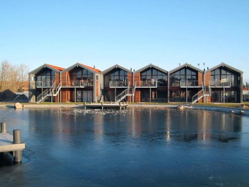 a building with windows and a body of water at 4 person holiday home in Bogense-By Traum in Bogense