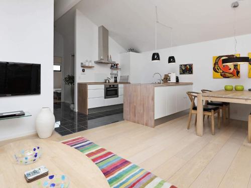 a kitchen and living room with a table and a dining room at 4 person holiday home in Bogense-By Traum in Bogense
