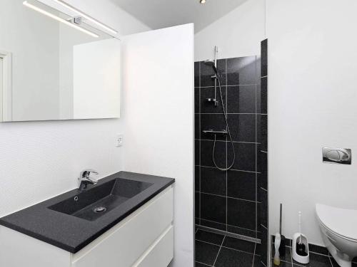 a bathroom with a black sink and a shower at 4 person holiday home in Bogense-By Traum in Bogense