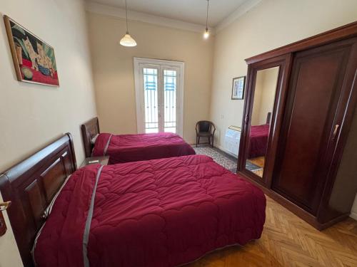 a bedroom with two beds and a mirror at Zamalek Garden villa-at the Nile in Cairo