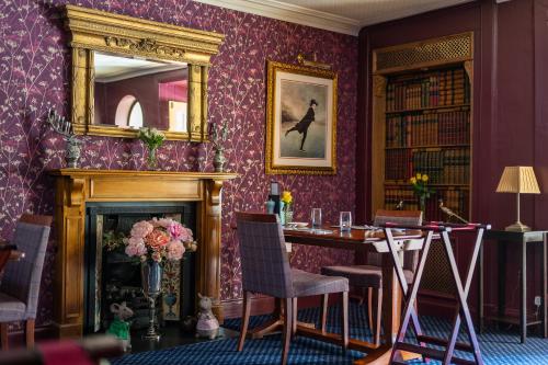 a dining room with a table and a mirror at The Open Arms Hotel in Dirleton