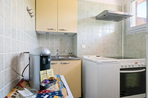 a kitchen with a counter with a coffee maker at LE PANORAMA -Vue Exceptionnelle - Dernier étage - Front de Mer in Menton