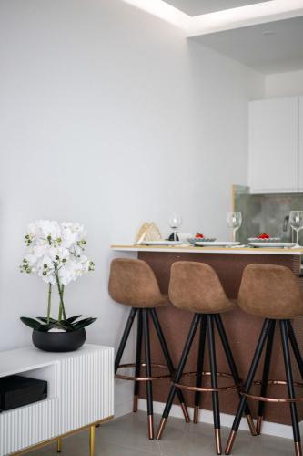 a kitchen with a counter and two stools at Amazonico - Proche Centre - Clim - Plage in Menton