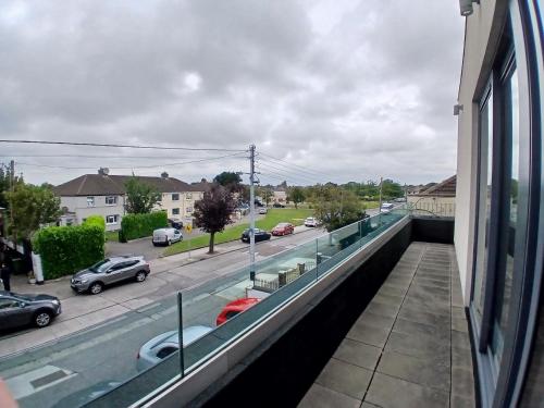 a view of a city street from a balcony at Newly Refurbed 2BD Wraparound Balcony 5km to City in Dublin
