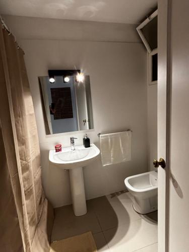 a bathroom with a sink and a toilet at Frente al mar in Montevideo
