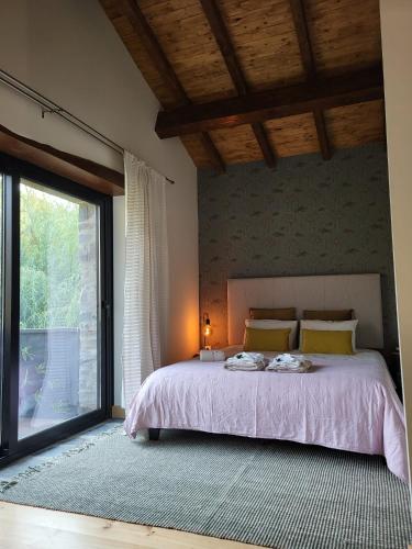a bedroom with a bed and a large window at Xisto in Semide