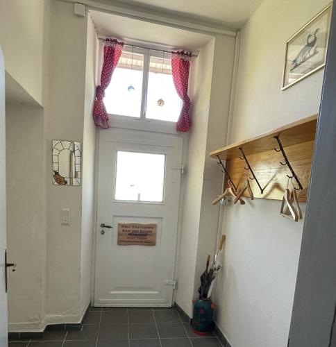 a hallway with a white door and a window at Ferienwohnung Altes Rathaus Bergalingen in Rickenbach