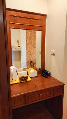 a mirror on a wooden dresser in a room at Mild Garden View Resort in Ao Nang Beach
