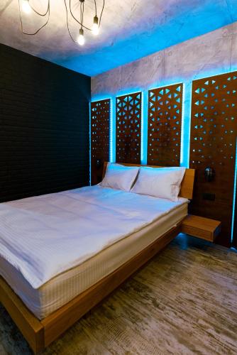 a bedroom with a large bed with white sheets at The Industry in Galaţi