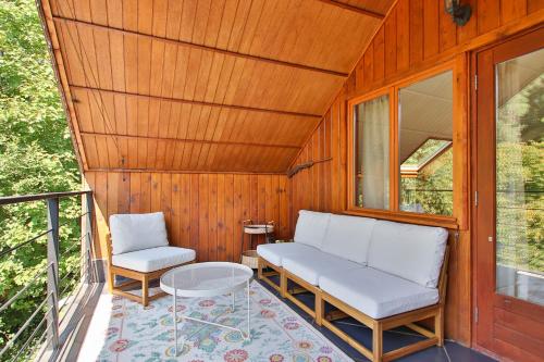 a porch with two chairs and a couch and a table at Gite Moments à Soy in Soy