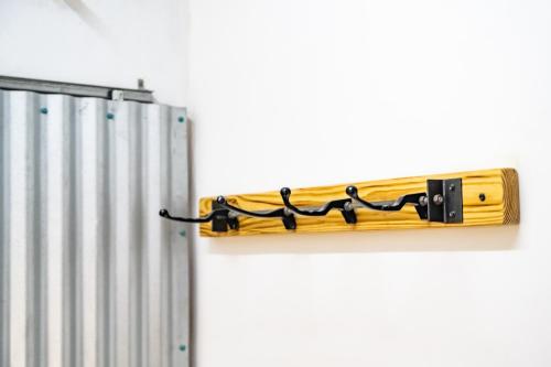 a wooden towel rack hanging on a wall next to a radiator at Crash Pad Adventure Hostel in Hopkins