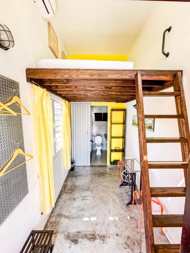 a room with a loft bed and a staircase at Crash Pad Adventure Hostel in Hopkins