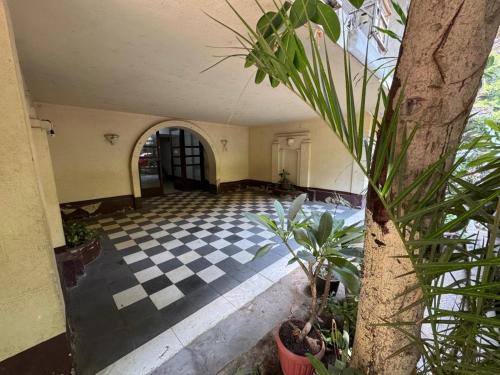 an empty hallway with a checkered floor and plants at Prime location 2 bed rooms Apartment , near the Nile & Cairo Center in Cairo