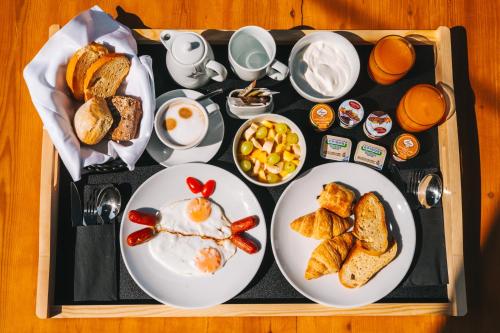 a tray of breakfast food with eggs and toast at Alaya Suites in Pirgos