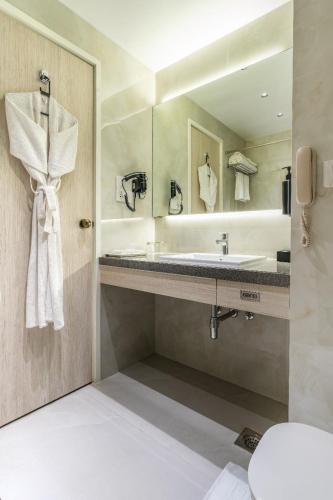 a bathroom with a sink and a mirror at Hotel Kohinoor Continental, Airport - Newly Renovated in Mumbai