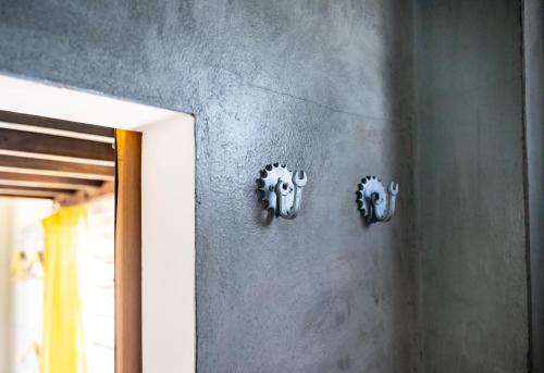 two metal objects on the wall of a room at Crash Pad Adventure Hostel in Hopkins