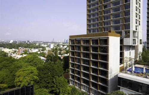 a tall building in front of a city at NH Guadalajara Studios in Guadalajara