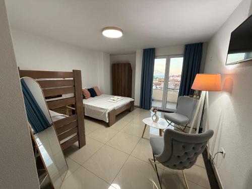 a small room with a bed and a bunk bed at Hotel Majestic in Struga