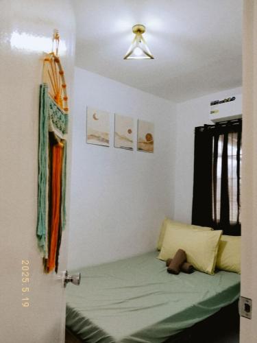 a room with a bed in a room at Sorelle- a cozy home in Manolo Fortich