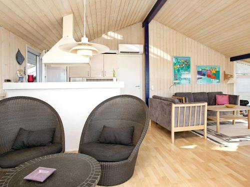 a living room with two chairs and a table at 8 person holiday home in Hjørring-By Traum in Lønstrup