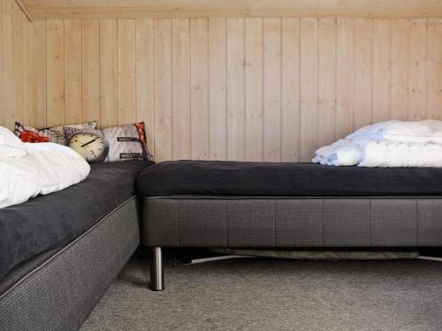 two beds sitting next to each other in a room at 8 person holiday home in Hjørring-By Traum in Lønstrup