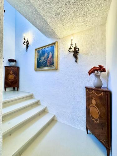 a room with stairs and a painting on the wall at Palazzo dei Fiori since 1883 in Ħal Balzan