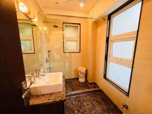 a bathroom with a sink and a mirror at Grove Residency Hauz Khas Couple Friendly New Delhi in New Delhi