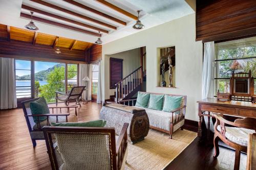 a living room with a couch and a table at JA Enchanted Island Resort Seychelles in Round Island