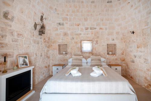Postel nebo postele na pokoji v ubytování Il Trullo di Grace Castellana