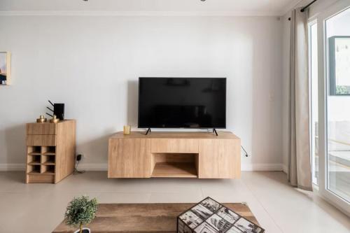 a living room with a flat screen tv on a wall at Beautiful Condo just steps from Avenida Escazu in an unbeatable location in San Rafael