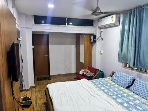 a hospital room with a bed and a tv at Siv villa in Kāhārpāra