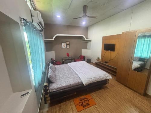 a hospital room with a bed and a tv at Siv villa in Kāhārpāra