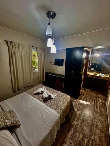 a bedroom with a bed with a stuffed animal on it at Castelar in Mendoza