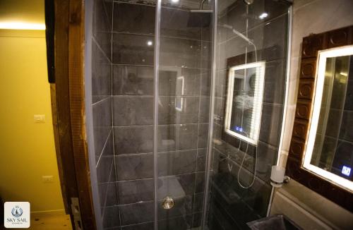 a bathroom with a shower with black tiles at Sky Sail Dahabiya in Aswan