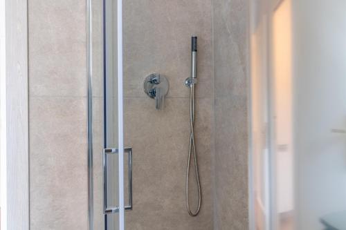 a shower with a shower head in a bathroom at Apartment Next to St Peter in Rome