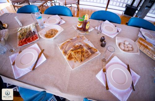 a table with plates of food on top of it at Sky Sail Dahabiya in Aswan