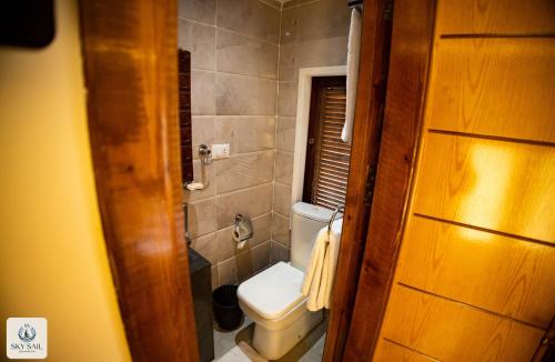 a small bathroom with a toilet and a window at Sky Sail Dahabiya in Aswan