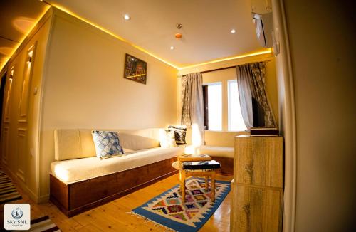 a living room with a couch and a table at Sky Sail Dahabiya in Aswan