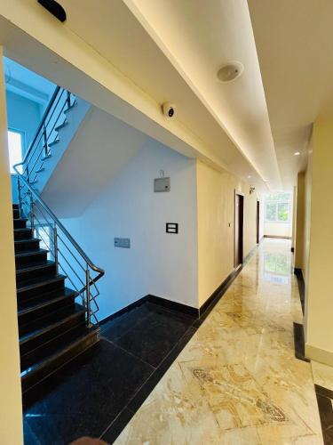 a staircase in a house with blue ceilings at Hotel Maharani Grand Patna in Patna