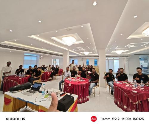 a group of people sitting at tables in a room at Hotel Maharani Grand Patna in Patna