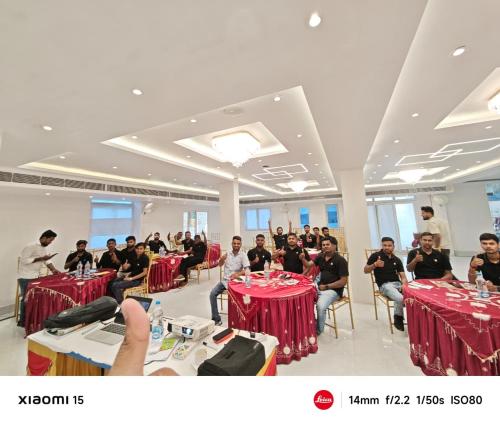 a group of people sitting at tables in a room at Hotel Maharani Grand Patna in Patna