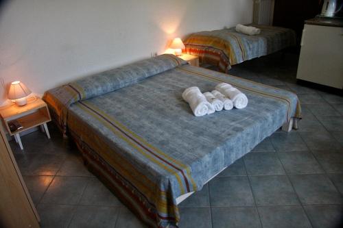 a bedroom with two beds with white towels on them at Farm stay Domačija Butul in Koper