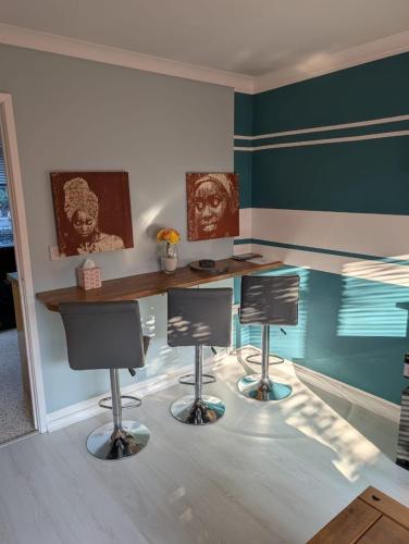 a room with two desks and two chairs in it at 2 Bedroom Guest House Near Beach in Llanelli