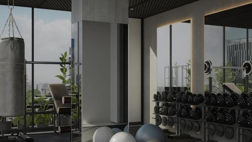 a living room with a balcony with chairs and windows at NH Guadalajara Studios in Guadalajara