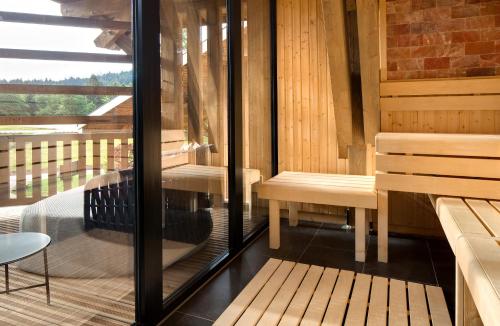 a sauna with two benches and a table at Domaine de Montagne - Hôtel Chalet Frère Joseph in Ventron