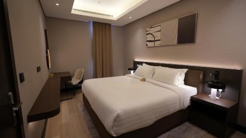 a hotel room with a bed and a desk at Snood Al Narjis Hotel in Riyadh