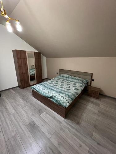 a bedroom with a bed and a wooden floor at VM Villa in Baku