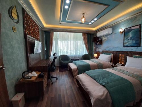 a hotel room with two beds and a window at Hotel Intercontinental Kabul in Kabul