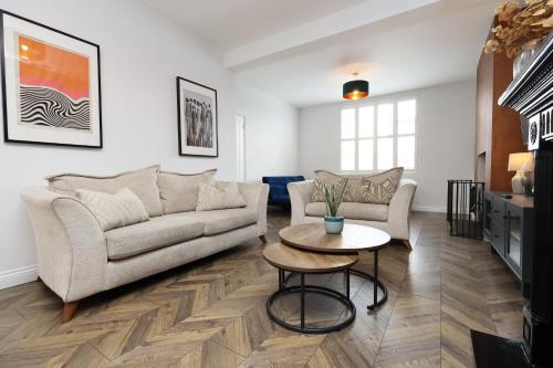 a living room with a couch and a table at Spacious 3 Bedroom Home in Heart Of Pontypool With Parking - By EKLIVING LUXE Short Lets & Serviced Accommodation in Griffithstown
