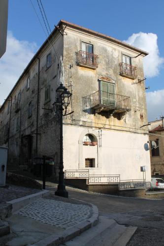 an old building with two balconies on a street at Affaccio sulla Piazza Carpinone in Carpinone
